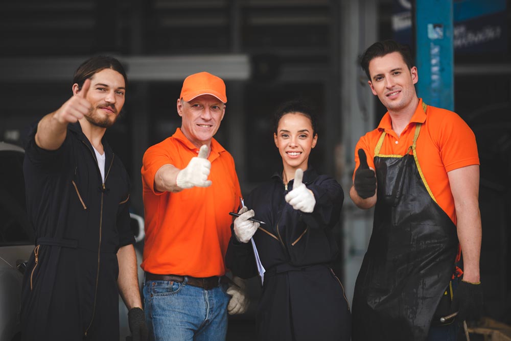group-of-young-and-senior-car-mechanics-in-garage2-2023-11-27-04-52-56-utc